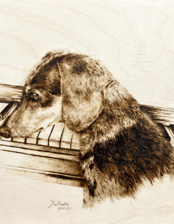 Pyrography piece featuring dog named Lily at the piano